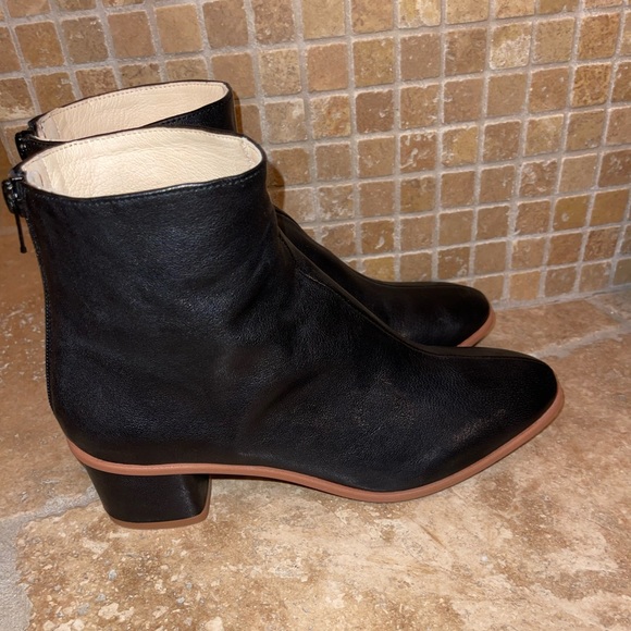 Anthropologie Shoes - Anthropologie booties in black with tan trim